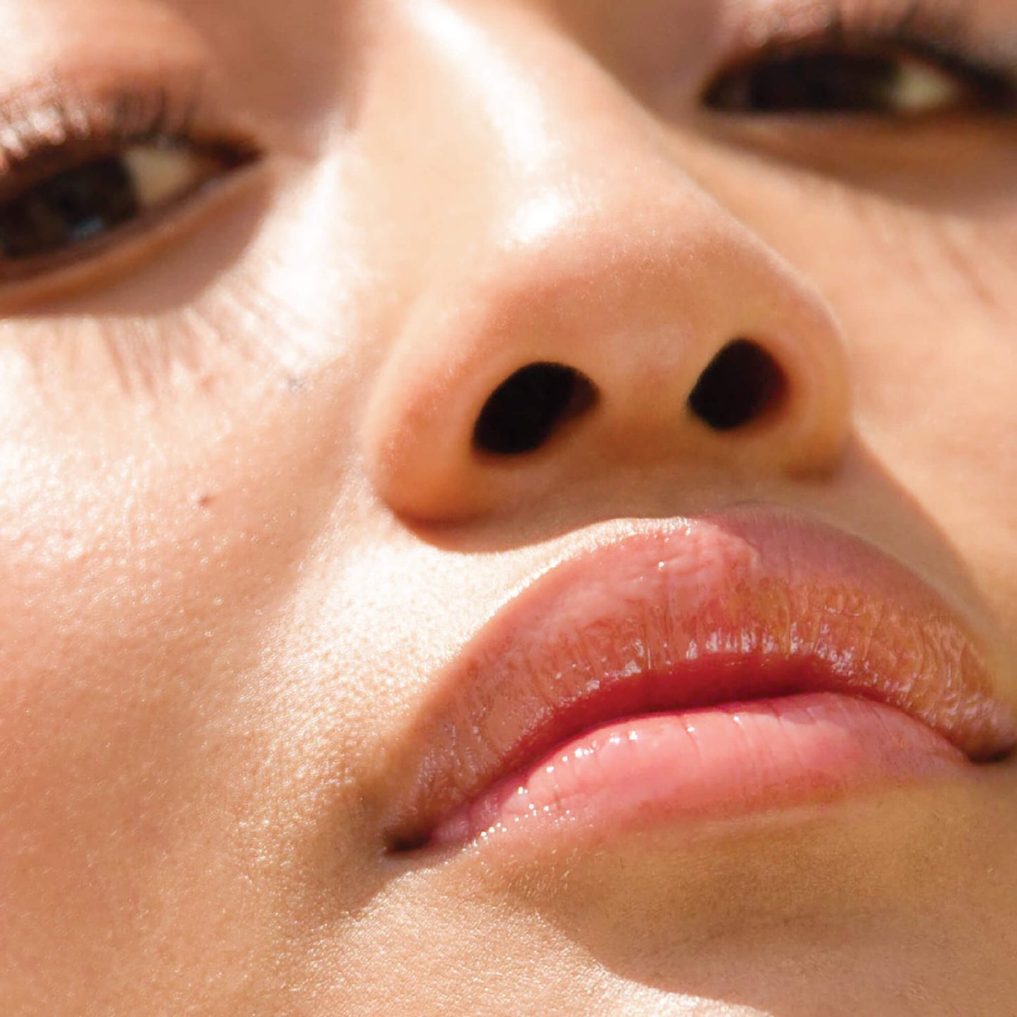 Oat [A model wearing the Tower 28 Beauty ShineOn Lip Jelly in the shade Oat on her lips]