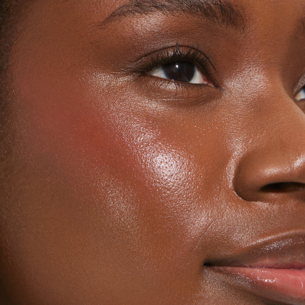 A close up of a model with Tower 28 Beauty's BeachPlease Cream Blush in Power Hour on her face.