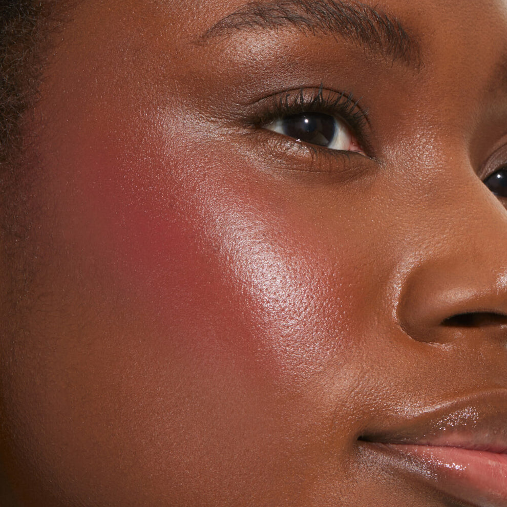 A close up of a model with Tower 28 Beauty's BeachPlease Cream Blush in After Hours on her face.