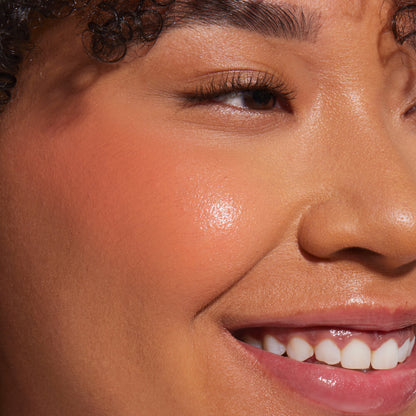 Rush Hour [A close up of a model with Tower 28 Beauty's BeachPlease Cream Blush in Rush Hour on her face.]