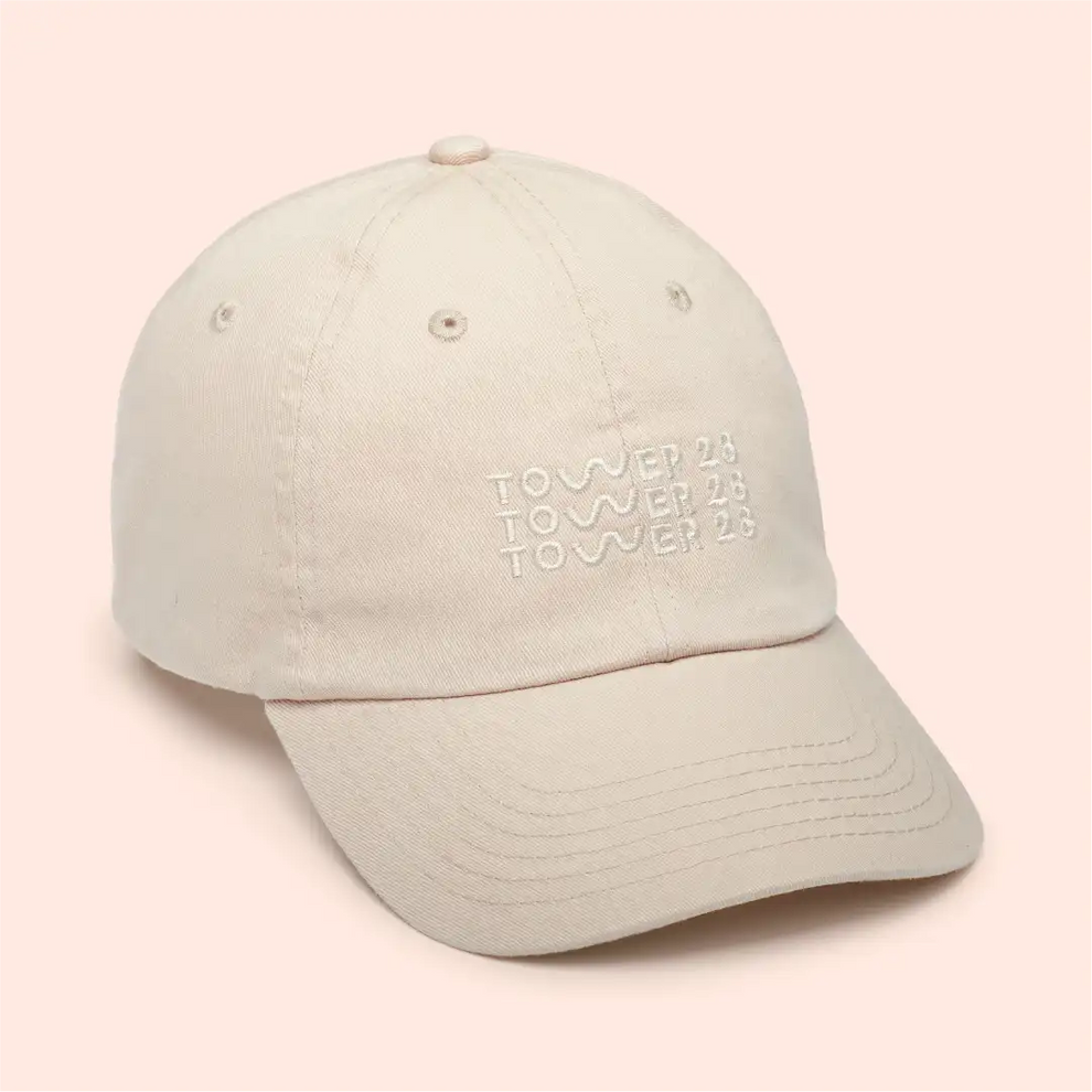 [Shared: Girl wearing Tower 28 Beauty Classic Baseball Cap Embroidered Baseball Hat with Adjustable Closure in Oatmeal Cream Color