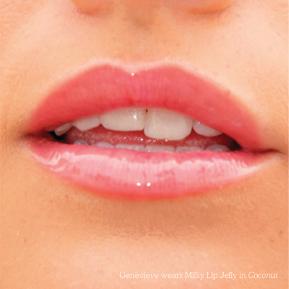 Coconut [Closeup photo of very glossy lips, wearing the Tower 28 Beauty ShineOn Milky Lip Jelly shade in Coconut (a milky mauve-pink)]