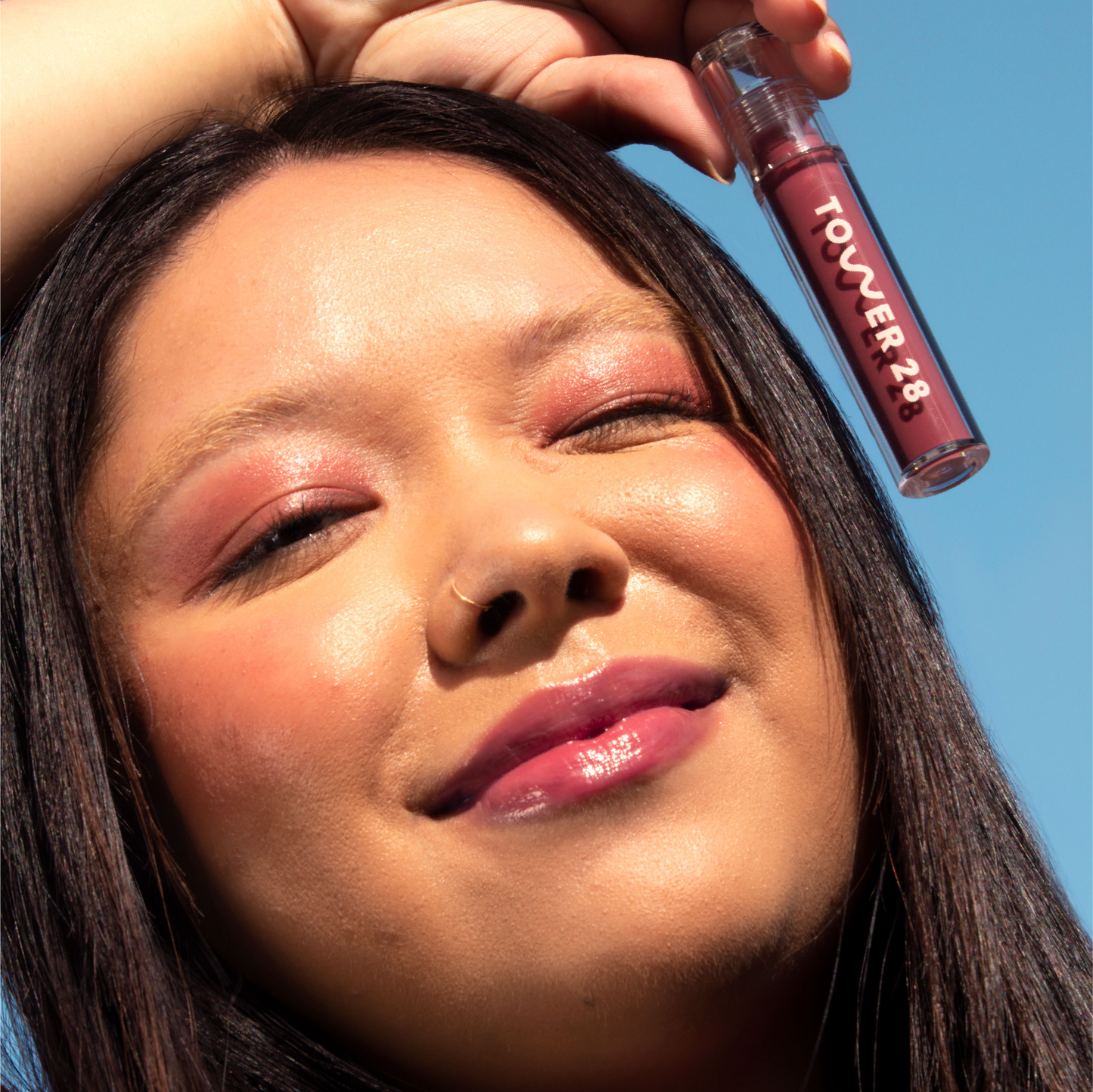 Sesame [Closeup photo of a girl with very glossy lips, wearing the Tower 28 Beauty ShineOn Milky Lip Jelly shade in Sesame]